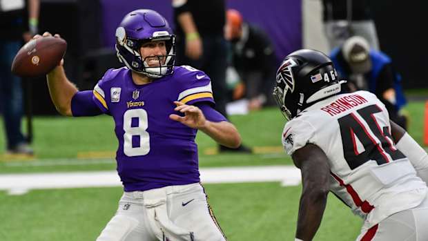 Oct 18, 2020; Minneapolis, Minnesota, USA; Minnesota Vikings quarterback Kirk Cousins (8) prepares to throw a pass as Atlanta Falcons linebacker Edmond Robinson (46) rushes during the first quarter at U.S. Bank Stadium.